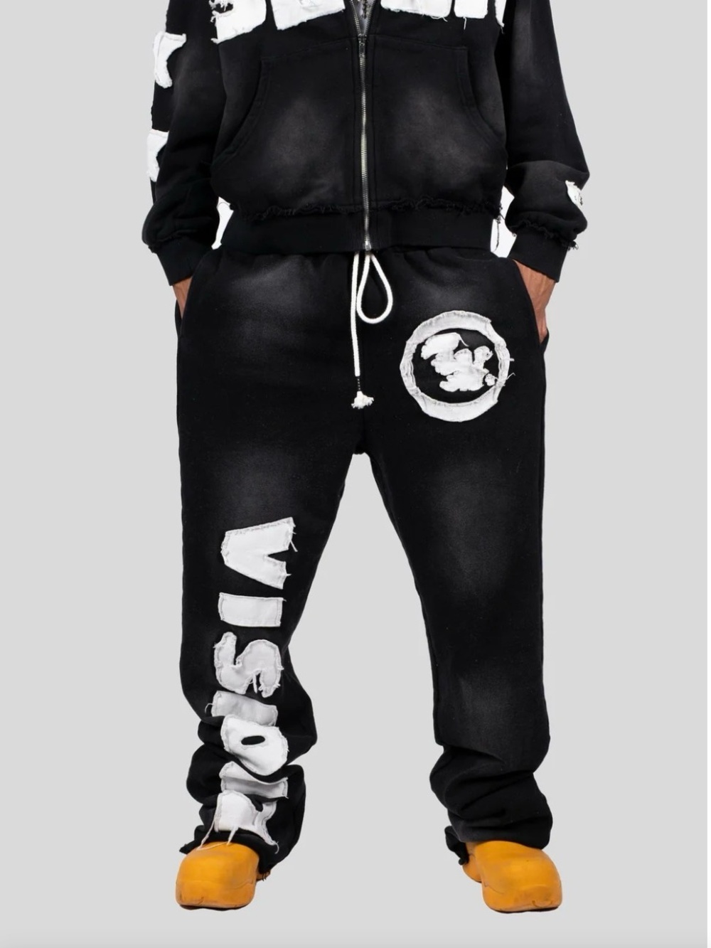 Visionz Sweats" in Onyx Black by the streetwear brand Timeloop Visionz.